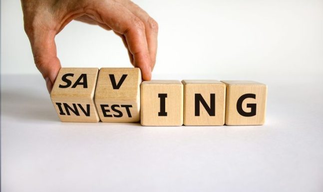 Saving,Or,Investing,Symbol.,Businessman,Turns,Cubes,And,Changes,The Saving,Or,Investing,Symbol.,Businessman,Turns,Cubes,And,Changes,The